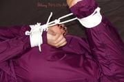 Shelly tied and gagged in a shiny nylon rainauit 