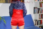 Jill posing and playing with you and herself wearing a sexy red shiny nylon shorts and an oldschool red/blue rain jacket (Pics)
