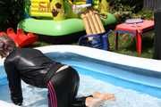 Watching sexy Mara going into the swimming pool wearing a sexy black/pink rainwear combination (Pics)