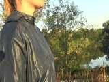 Get a Video with Sandra walking in her shiny nylon Rainsuit at a very hot and sunny day