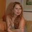Chubby redhead Benita stripping out of her grey dress and stockings on couch