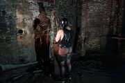 Slave in latex and chains in the horror tower