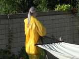 Watch Chloe enjoying the warm Sun in her yellow shiny nylon Rainsuit 