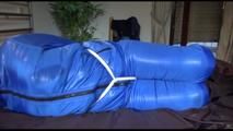 Jill tied, gagged and hooded on bed wearing a supersexy supershiny lightblue downwear (Video)