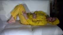 Watching Pia preparing her sofa with a shiny nylon cloth wearing a yellow shiny nylon rainsuit enjoying herslef on the sofa (Video)