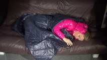 Watching sexy Sandra wearing a sexy pink shiny nlon rain pants and a shiny nylon pink down jacket nestle down in a down cover (Video)