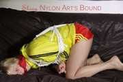 Sexy Lucy tied an gagged with ropes and a cloth gag wearing a super hot red shiny nylon shorts and a yellow rain jacket (Pics)