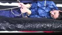 Lucy ties and gagges herself with cuffs on a bed wearing sexy blue shiny nylon rainwear (Video)