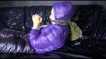 Sandra tied and gagged on a sofa wearing a shiny nylon down jacket and a rain pants (Video)