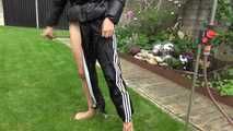 Watching Aiyana wearing a sexy black shiny nylon rainpant and a black shiny nylon down jacket trying the garden shower  (Video)