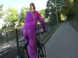 Watch Sandra riding her Bike in her sexy pink shiny nylon Rainsuit