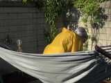 Watch Chloe enjoying the warm Sun in her yellow shiny nylon Rainsuit 