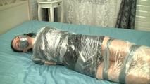 [From archive] Canella - Hogtaped and wrapped in trash bag dress (video)