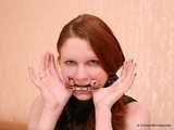 Gatitta - Pale, innocent-looking redhead uses thumb and toe cuffs