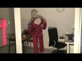 Blonde-haired archive girl being at home wearing shiny nylon rainwear (Video)