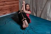 Tied suspended legs in leggings and red dress
