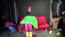 Watching sexy Pia being tied and gagged with ropes and a clothgag on a hairdressers chair wearing a very sexy pink rainwear combination with hood (Video)