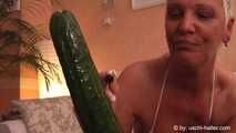 MILF fucks herself with a cucumber