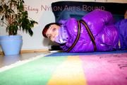 Jill tied and gagged with webbing load restraint assembly on the floor wearing a sexy purple down jacket and a rain pants (Pics)
