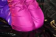 Pia wearing a pink rain pants and a purple down jacket tied with cuffs and gagged on bed (Pics) 