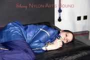 Lucy tied with cuffs overhead and gagged with a clothgag wearing sexy blue rain pants and a raincoat (Pics)