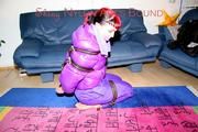 Jill tied and gagged with webbing load restraint assembly on the floor wearing a sexy purple down jacket and a rain pants (Pics)