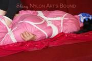 Lucy tied and gagged on a sofa wearing a pink shiny nylon skibib (Pics)