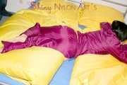 ENNI wearing a sexy purple shiny nylon rain suit lying in bed with yellow shiny nylon cloths lolling and posing (Pics)