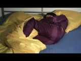 ENNI wearing a sexy purple shiny nylon rain suit lying in bed with yellow shiny nylon cloths lolling and posing (Video)