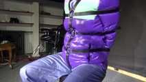 Watching Sandra wearing a sexy shiny nylon rain pants and a downjacket being tied, gagged and hooded with leather straps and a ballgag with eye patches (Video)