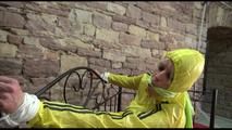 Pia tied and gagged on a princess bed wearing a sexy shiny black shorts and a yellow rain jacket (Video)