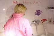 Sonja wearing a sexy pink down suit playing with the foam in her bath tub and enjoying the feeling in the wet clothes (Pics)