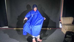 Watching Sonja sitting on a hairdresser`s chair wearing sexy blue shiny nylon rainwear with a raincape being tied, gagged and hooded with ropes and a clothgag (Video)