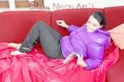 SEXY JILL lounging on the sofa wearing a sexy black shiny nylon rain pants and a purple shiny nylon down jacket (Pics)