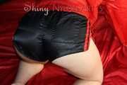 Watching sexy SONJA wearing a sexy black shiny nylon shorts and a red rainjacket preparing her lolling area (Pics)