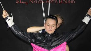 Sexy Mara tied, gagged and hooded overhead on hands and feet with ropes and a cloth gag wearing a sexy black/pink rainwear combination (Pics)
