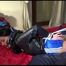 Lucy tied and gagged on bed wearing a sexy blue shiny nylon shorts with shadow stripes and a black rain jacket (Video)