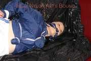 LUCY tied and gagged with ropes and a cloth gag wearing a supersexy white shiny nylon shorts and blue rain jacket (Pics)