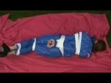 a video with Nicole tied and gagged in a shiny blue PVC suit