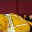 Lucy tied and gagged on a red sofa wearing a supersexy yellow shiny nylon shorts and a yelow rain jacket (Video)