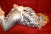 Sophie tied and gagged on the sofa wearing a shiny silver PVC sauna suit (Pics)