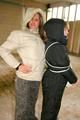 Blond-haired archive girl tied and gagged by another archive girl wearing shiny down jackets (Pics)