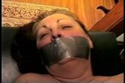46 Yr OLD REAL ESTATE AGENT'S IS MOUTH STUFFED, HANDGAGGED, DUCT TAPE GAGGED, TOP-LESS, TIT TIED, FONDLED, TOE-TIED, UPSKIRT AND TIGHTLY TIED ON A MASSAGE TABLE  (D69-11)