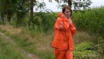 Miss Petra takes a walk in a orange AGU rain suit and rubber boots