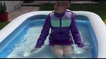 Watching Mara wearing a supersexy purple down skirt and a purple down jacket cleaning the swimming pool and playing with water (Video)