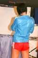 SEXY ENNI wearing a hot red shiny nylon shorts and a lightblue shiny nylon rain jacket during ironing the shirt of her boyfriend (Pics)