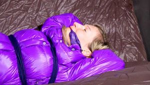 *** HOT HOT HOT*** NEW MODELL*** SANDRA wearing a sexy transparent purple shiny nylon pants and a purple down jacket tied and gagged on a sofa with ropes hand to feet and a cloth gag (Pics)