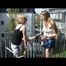 Katharina and a blonde archive girl at home preparing coffee and and lolling on the balcony wearing shiny nylon shorts and a rain jacket (Video)