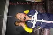 Sandra tied by Stella both wearing shiny nylon rainwear