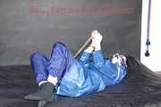 Lucy tied with cuffs overhead and gagged with a clothgag wearing sexy blue rain pants and a raincoat (Pics)